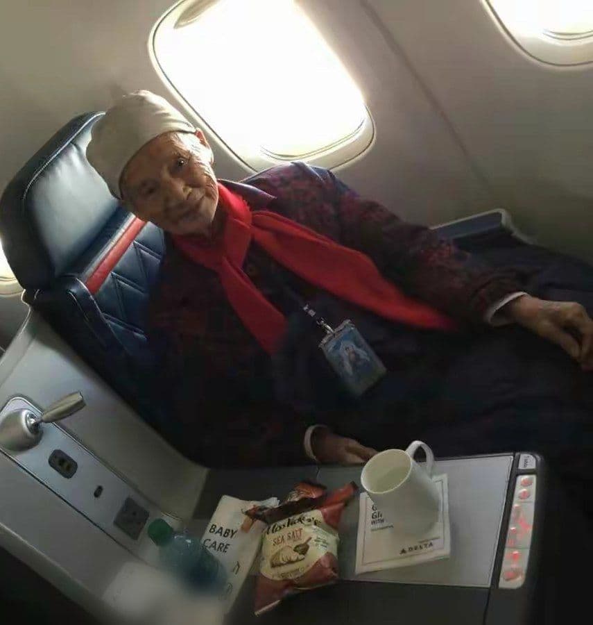 Our mother, 99, smiling from her window seat on a flight.